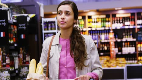 Woman-walking-with-shopping-cart-in-grocery-section
