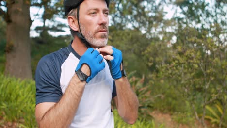 Male-cyclist-wearing-helmet-at-countryside