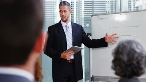 Businessman-giving-a-presentation-in-a-meeting