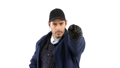 Security-guard-standing-and-pointing-on-white-background