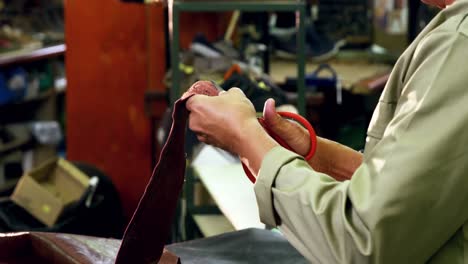 Cobbler-cutting-a-piece-of-leather