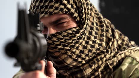 Soldier-with-covered-face-aiming-rifle