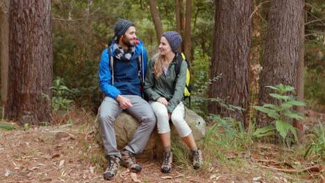 Hiker-couple-sitting-together-on-rock