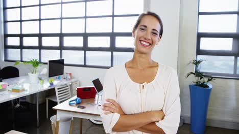 Female-business-executive-standing-with-arms-crossed