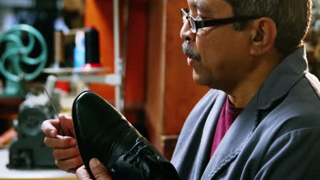 Shoemaker-repairing-a-shoe