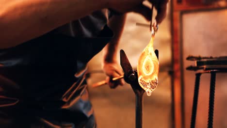 Glassblower-reheating-a-piece-of-glass-in-furnace
