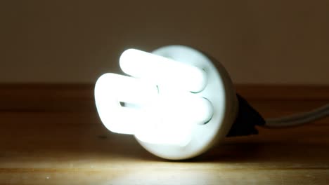 Close-up-of-bulb-glowing-on-a-table