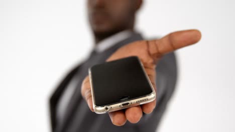 Close-up-of-businessman-hand-showing-mobile-phone