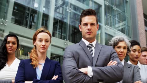 Businesspeople-standing-with-arms-crossed-in-office-building