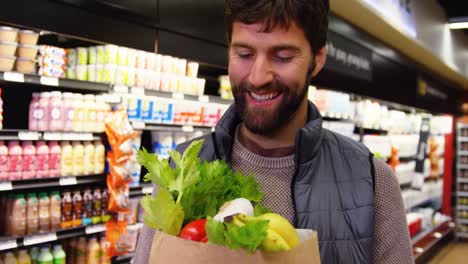 Man-holding-fruits-and-vegetables-in-paper-bag