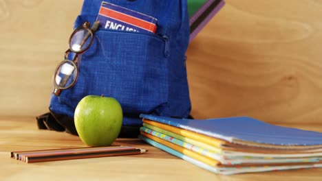 Close-up-of-school-bag-with-books-and-spectacles
