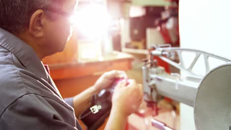 Shoemaker-using-sewing-machine
