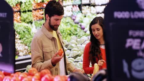 Couple-selecting-vegetables-from-organic-section