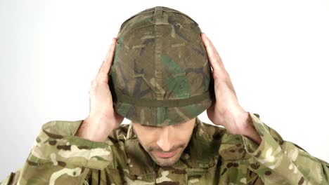 Soldier-wearing-combat-helmet-on-white-background