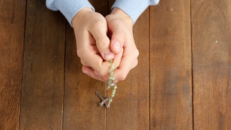 Praying-hands-holding-rosary