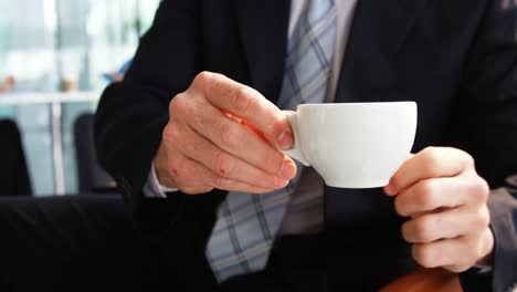 Businessman-having-cup-of-coffee-
