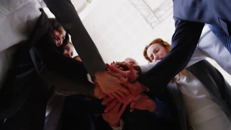 Businesspeople-forming-hands-stack