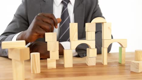 Businessman-playing-with-building-blocks