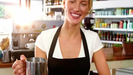 Portrait-of-waitress-making-cup-of-coffee-at-counter