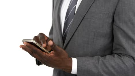 Mid-section-of-businessman-using-mobile-phone