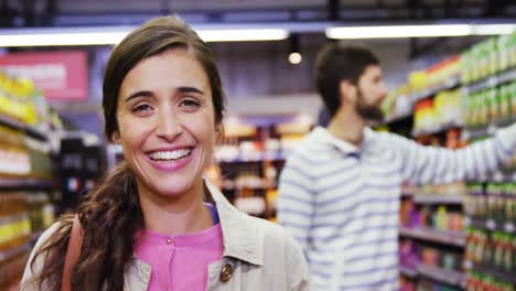 Portrait-of-woman-smiling-in-grocery-section