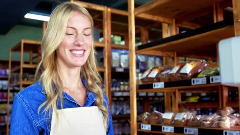 Smiling-female-staff-standing-in-super-market
