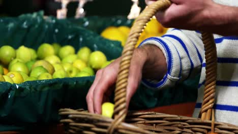 Man-with-a-basket-selecting-fruit-in-organic-section