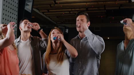 Group-of-friends-toasting-shot-glasses-of-tequila