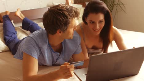 Couple-shopping-online-on-laptop-using-credit-card