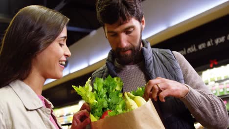 Smiling-couple-shopping-for-vegetables-in-organic-section