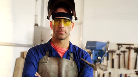 Portrait-of-male-welder-standing-with-arms-crossed