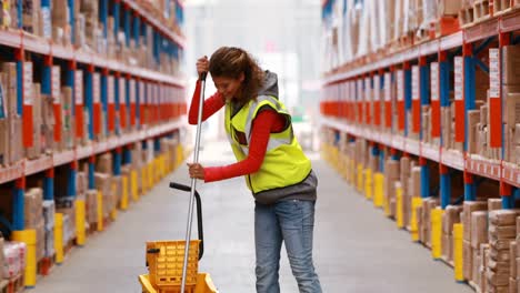 Female-warehouse-worker-moping-floor