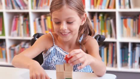 Disabled-girl-playing-with-building-blocks-in-library