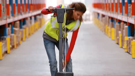 Female-warehouse-worker-cleaning-warehouse-floor