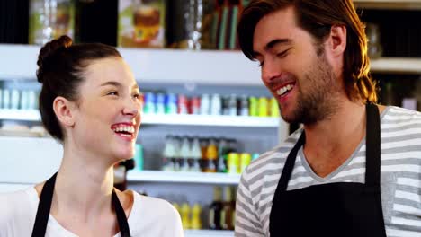 Waiter-and-waitress-interacting-with-each-other