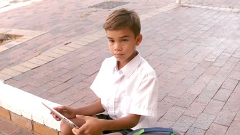 Portrait-of-cute-schoolboy-using-digital-tablet