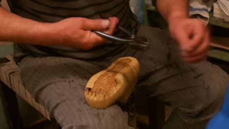Cobbler-repairing-a-shoe