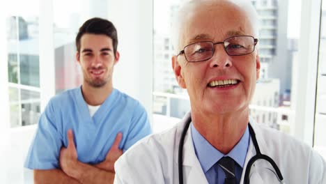 Portrait-of-male-doctors-and-coworker-standing-with-arms-crossed