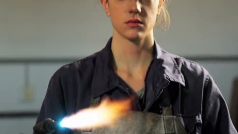 Female-welder-holding-welding-torch