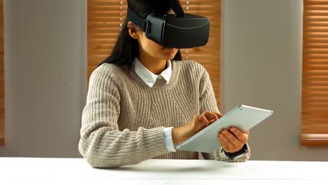 Female-business-executive-using-digital-tablet-with-virtual-glasses