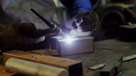 Male-welder-working-on-a-piece-of-metal
