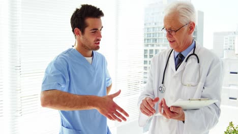 Male-doctor-shaking-hands-with-coworker