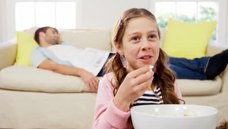 Girl-eating-popcorn-in-the-living-room