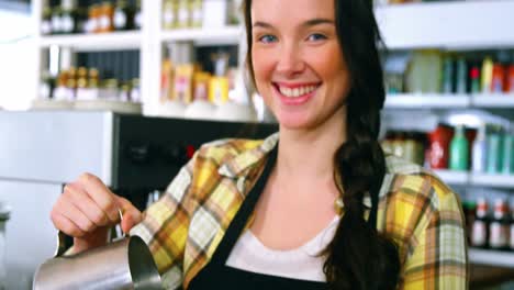Portrait-of-waitress-making-cup-of-coffee-at-counter
