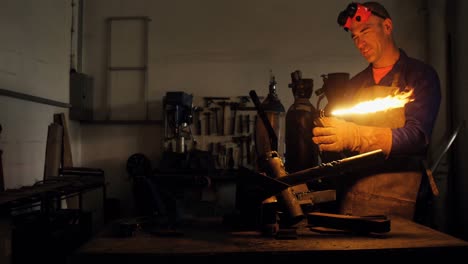 Welder-holding-welding-torch