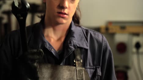 Female-welder-holding-wrench-tool