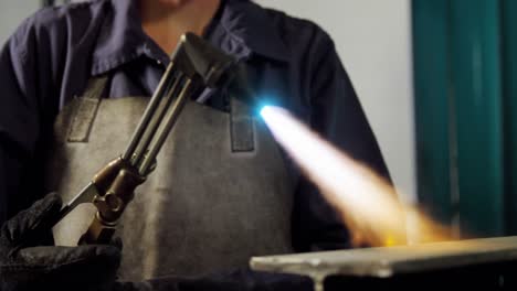 Female-welder-welding-a-metal