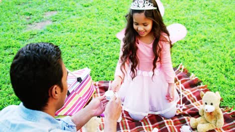 Father-and-daughter-having-toy-tea-party