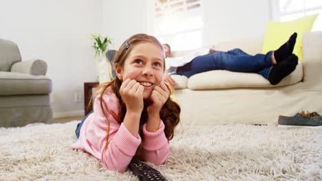 Girl-watching-tv-lying-on-the-rug-in-the-living-room