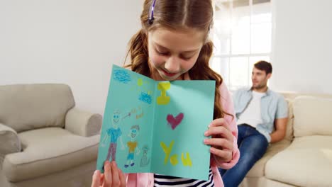 Daughter-holding-greeting-card